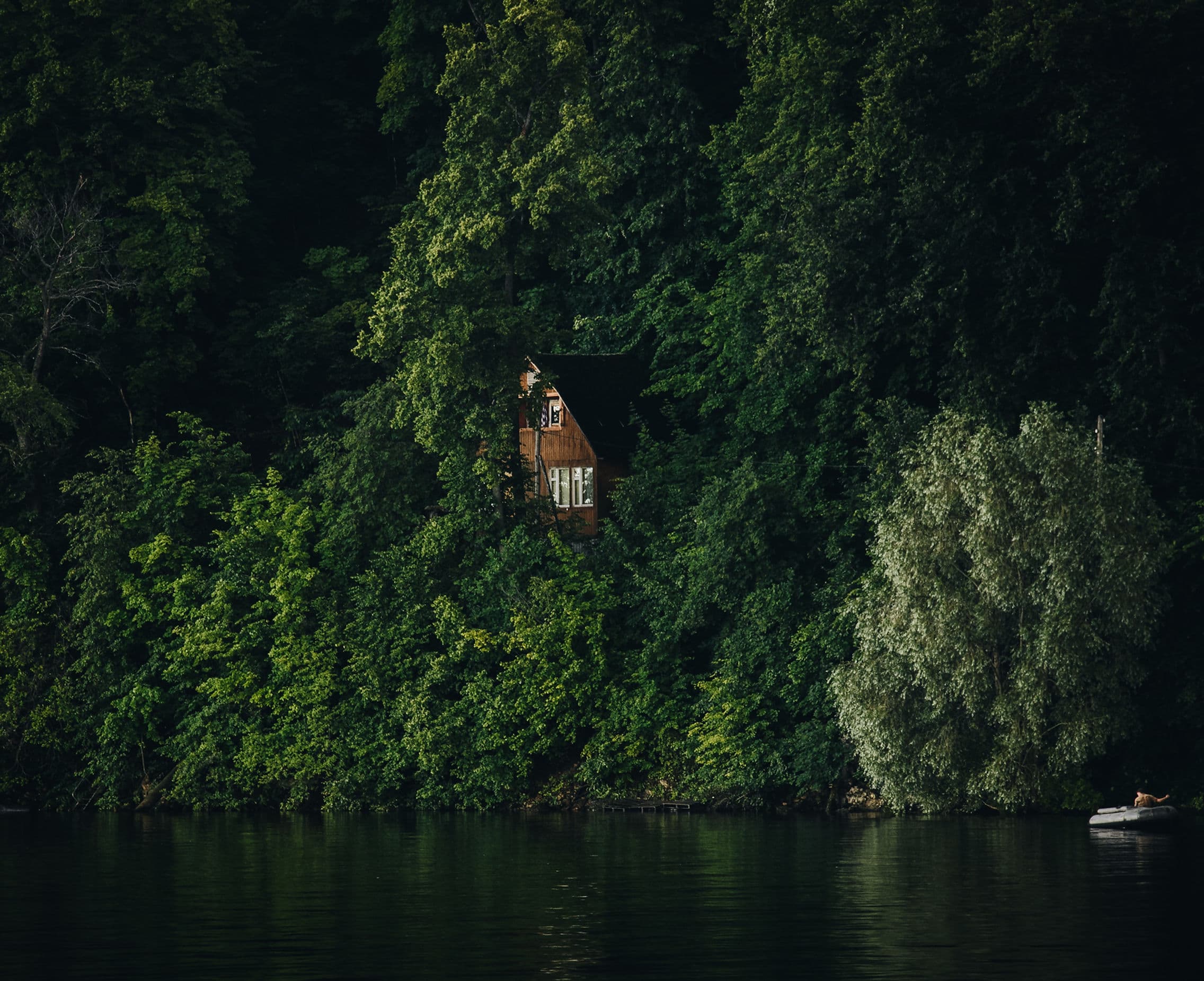 Lakeside cabin surrounded by forest — Retreat Vacation Rentals